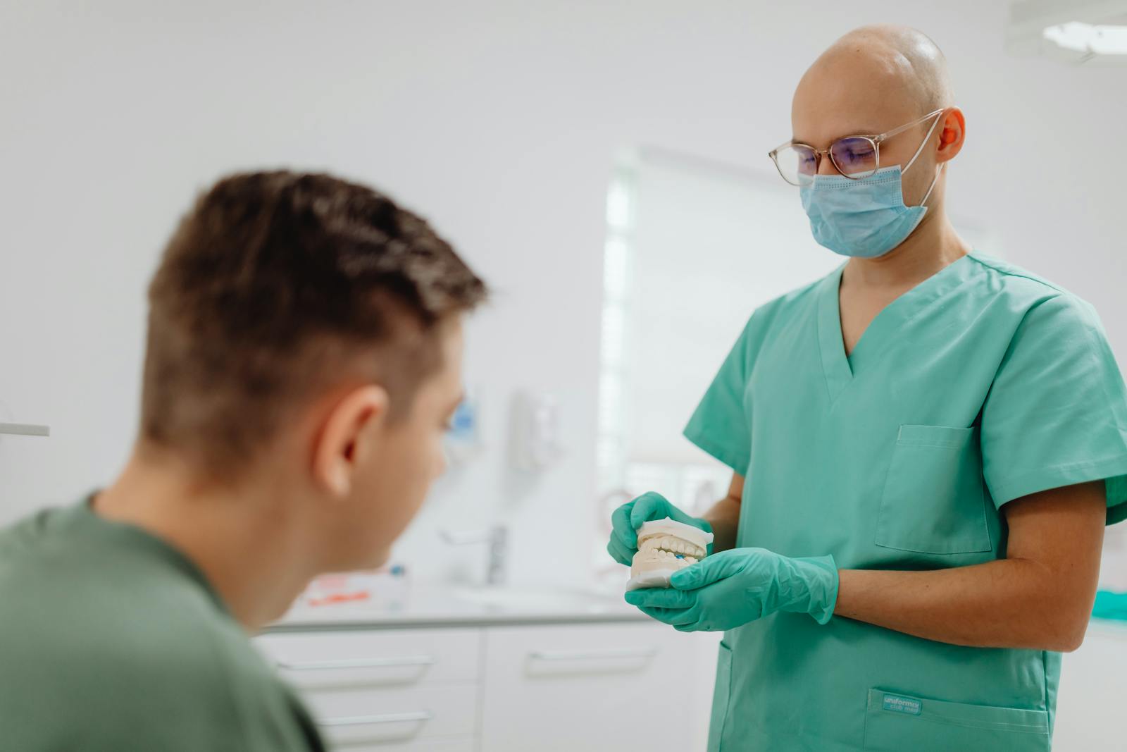 A dentist explaining a treatment to a patient